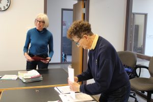 Photo of Karen Lee Weidig and Margaret Sommers stuffing folders for the Council’s Legislative Day.