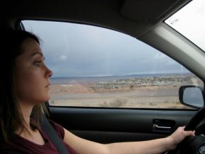 Girl driving a car.