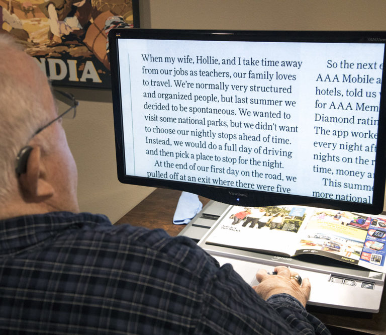 A man reads enlarged text on a CCTV.