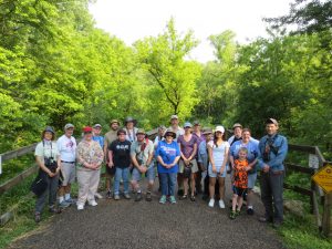 Birding by Ear participants stand on a trail in beautiful weather last summer.