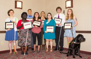 Scholarship recipients from 2018 hold their awards.
