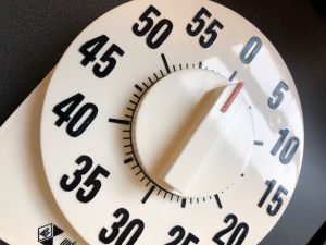 A close-up photo of a black and white kitchen timer.