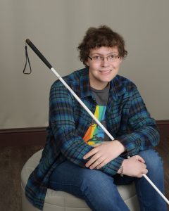 Young Man smiling with white cane