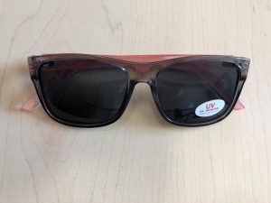 Sunglasses with a sticker that says “UV Eye Protection.”