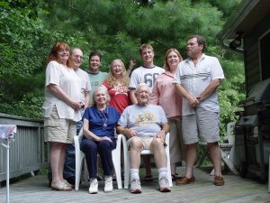 A multi-generational family on a porch. 
