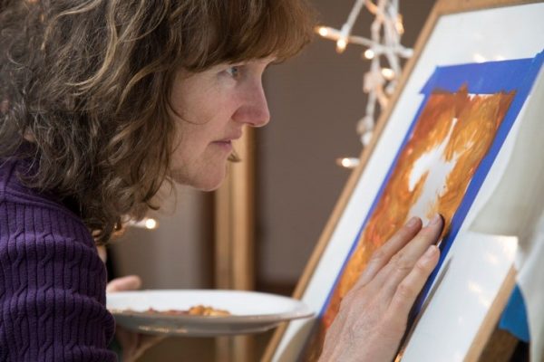 Artist Deb Claire working on art work