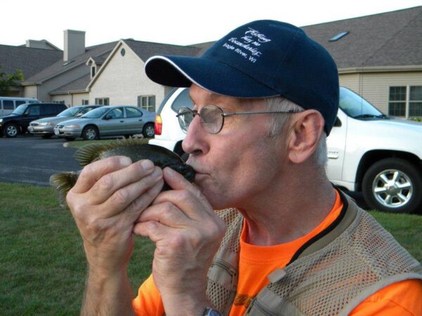 Man kissing fish