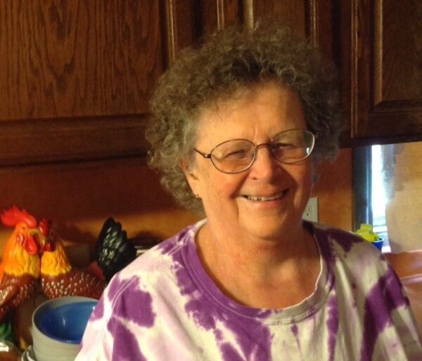  A woman stands in her kitchen.