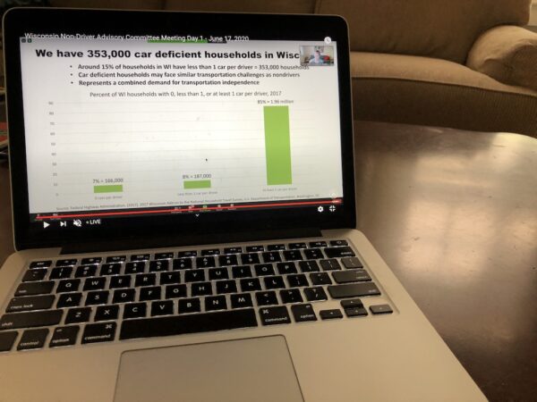 A laptop sits on a table with a presentation up.