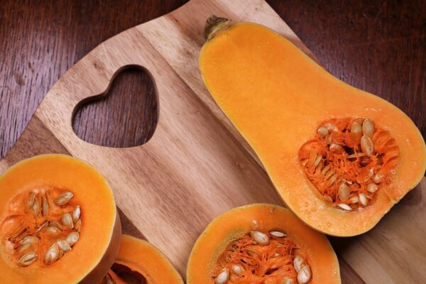 Slice butternut squash on a cutting board