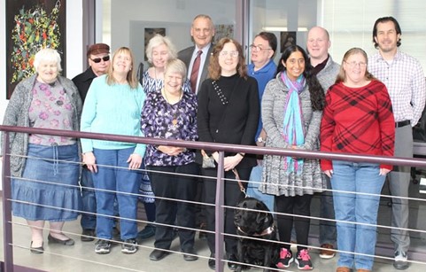 Our 12-member Board of Directors and a guide dog gathered at the Council offices.