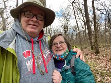 Jon Uzzel and Ellen Connor on a wooded trail.