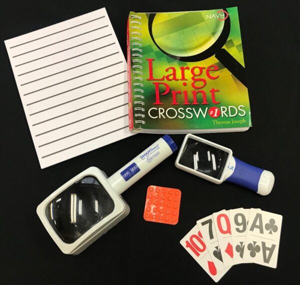 Adaptive products in a Personalized Low Vision Kits include magnifiers, large print crossword puzzle book, bump dots and large print playing cards.