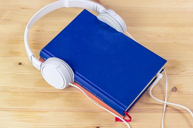 Blue book on table with headphones