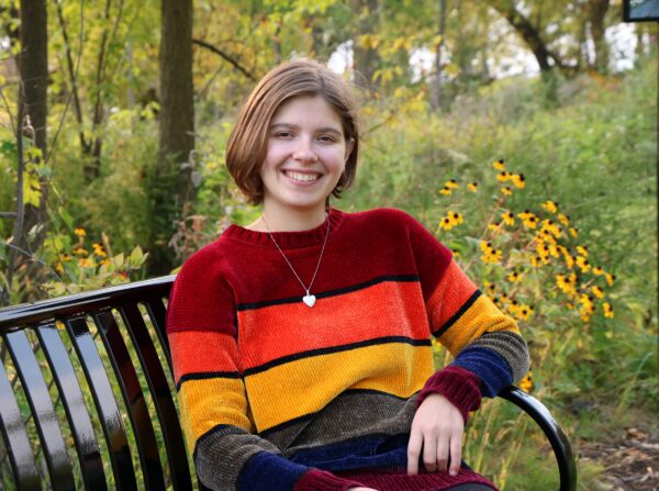 Ellie Thompson sitting on a bench