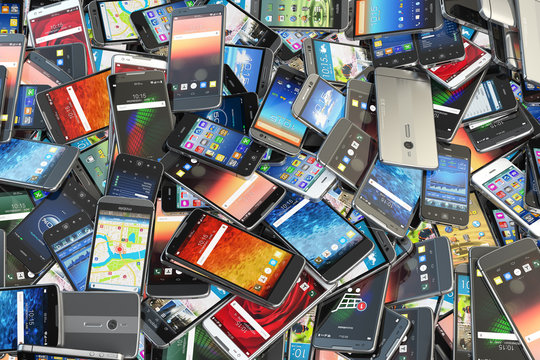 A large pile of cell phones of various brands and models.