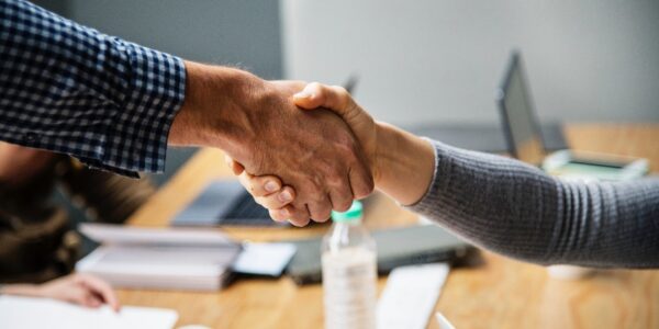 A handshake across a meeting table
