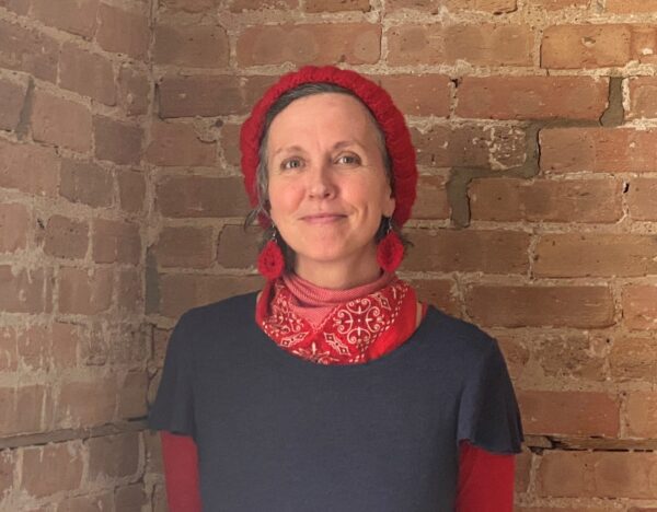 debbie rasmussen standing in front of a brick wall