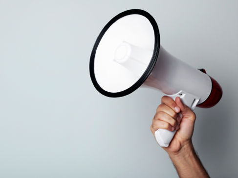 A hand holding a megaphone