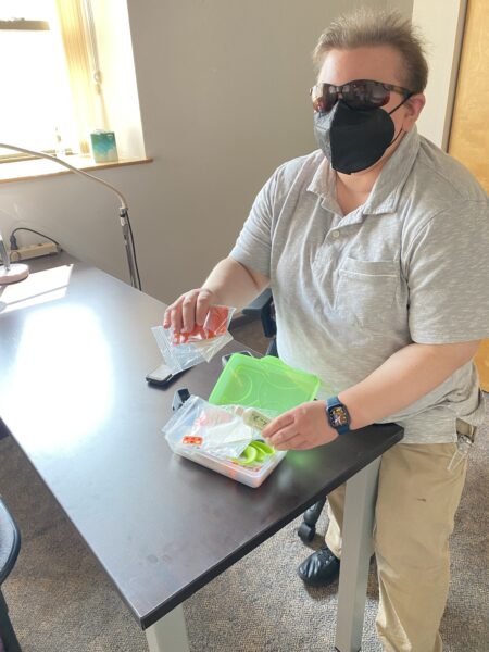Photo of Vision Rehabilitation Therapist showing items in the new on-site classroom