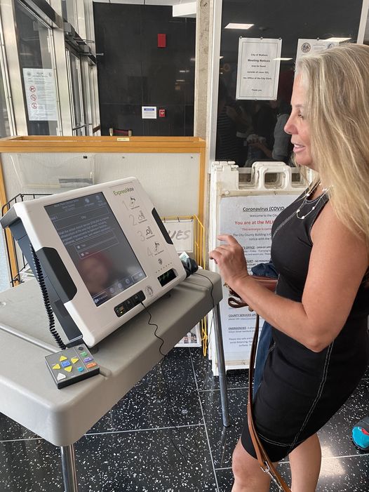 A woman using an accessible voting machine