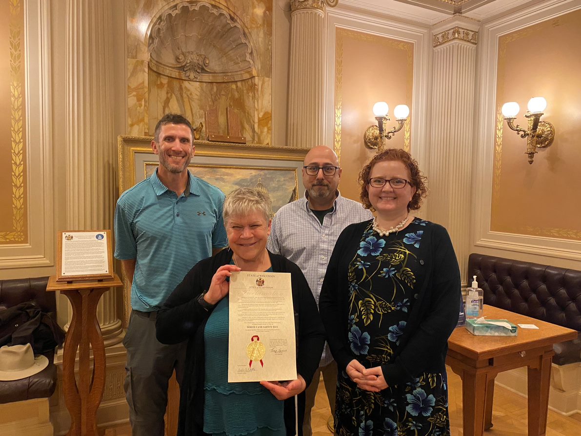 Four Council staff accepting a White Cane Safety Day at the Governors Office