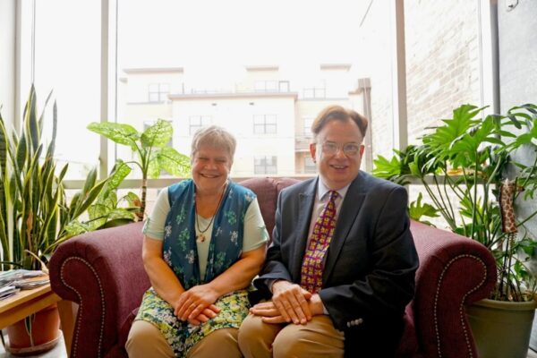 Denise Jess and Chris Richmond sitting on a sofa