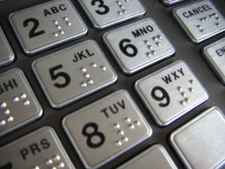 An ATM keypad with braille on the buttons