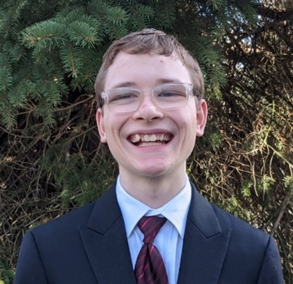 Nathan Schmitt standing in front of trees
