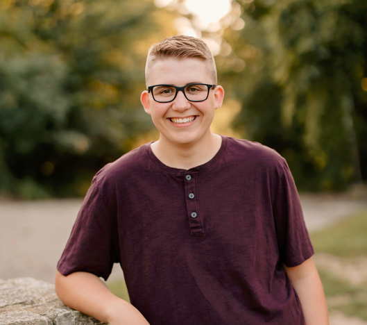 Jack Lichosik leaning his arm on a low stone wall
