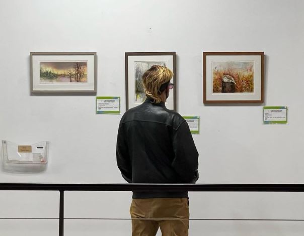 A man appreciates art from the 2022 Gallery Night.
