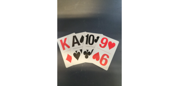 The king of diamonds, ace of spades, ten of clubs and nine of hearts from a pack of large print playing cards