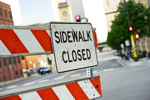 A Sidewalk Closed sign in a work zone