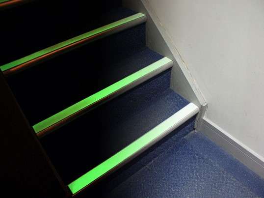 Stairs with bright green reflective tape on the edges