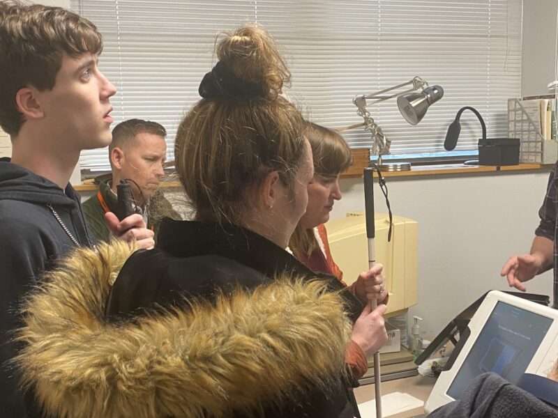 Students exploring an accessible voting machine