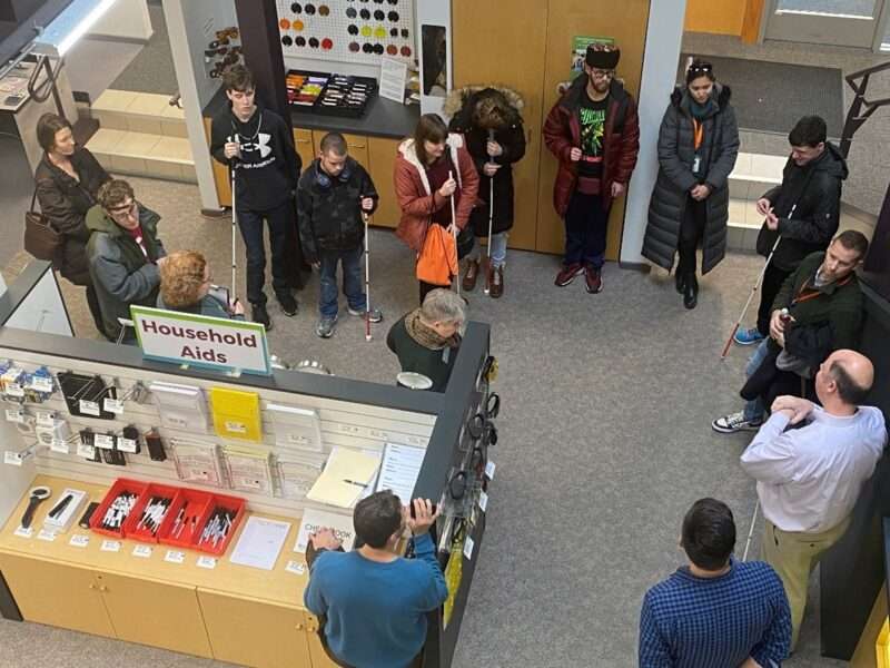 Students and Council staff standing in the Sharper Vision Store