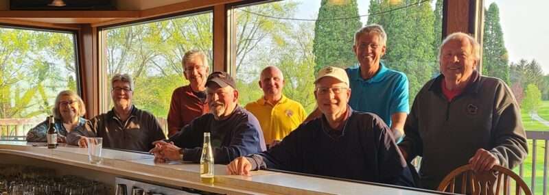 Members of the Town of Sheboygan Lions Club sitting and standing at a bar.