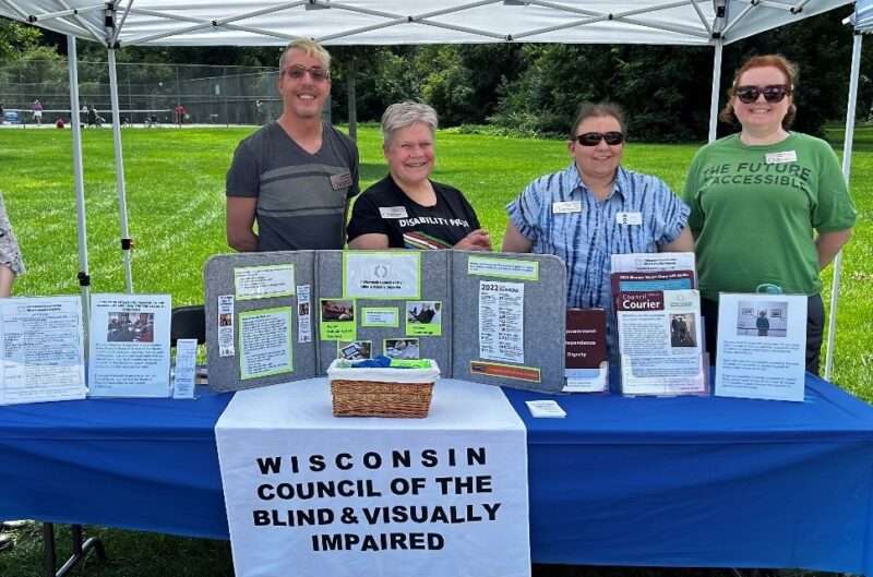 Council staff members standing behind the Council’s information table
