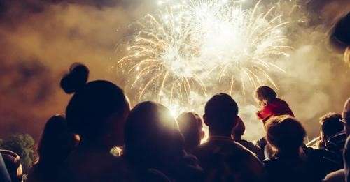 A group of people watching a fireworks display.