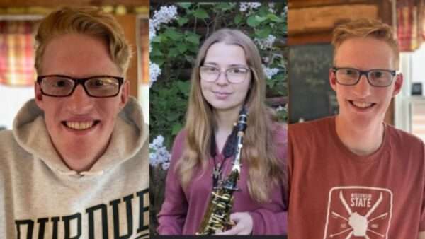 Three Scholarship Graduates - George Tuttle wearing a Purdue University hoodie, Grace Caine holding her saxophone, Joseph Tuttle smiling for the camera