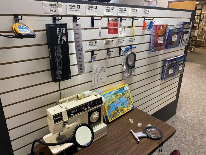Aisle in the Sharper Vision Store containing sewing items and crossword books.