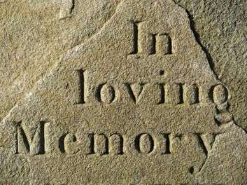The words In loving memory carved in stone.