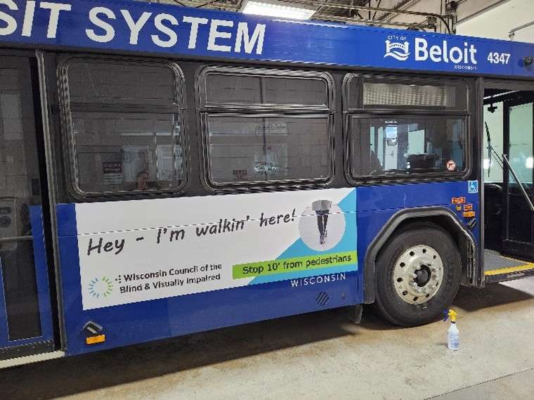 Beloit bus ad reading Hey, I’m walking here.