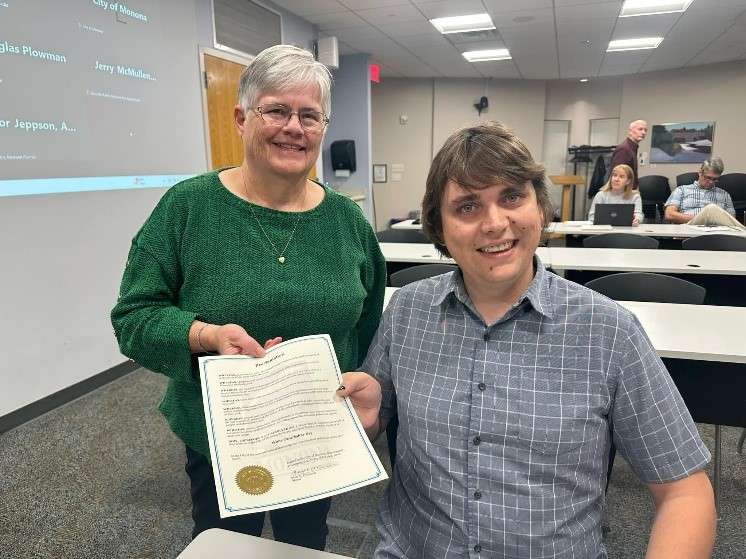 Nate Wegehaupt accepting a White Cane Safety Day proclamation from the mayor of Monona.