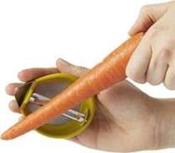 A person's hands peeling a carrot