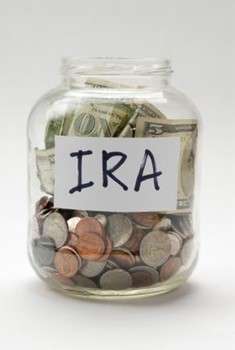 A jar of money with a label on it saying IRA.