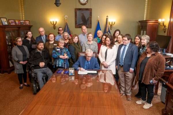 Governor Evers signing Steve's Law as advocates look on.