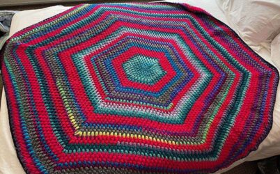 Multi-colored, hexagonal crocheted afghan using a puff stitch