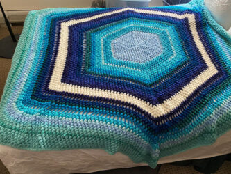 Crochet Afghan made of acrylic yarn in blue tones