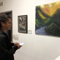 Woman looking at art during Gallery Night